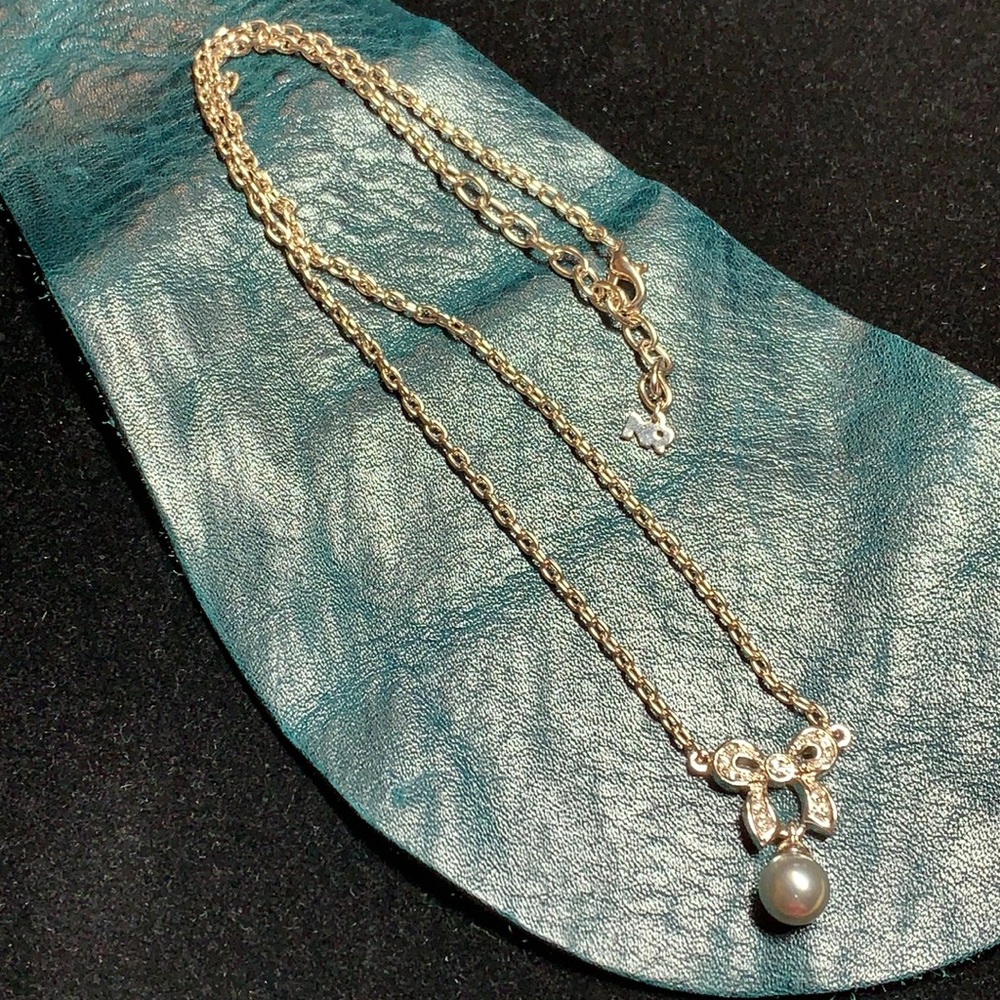 Nina Ricci, sparkly bow with grey faux pearl necklace